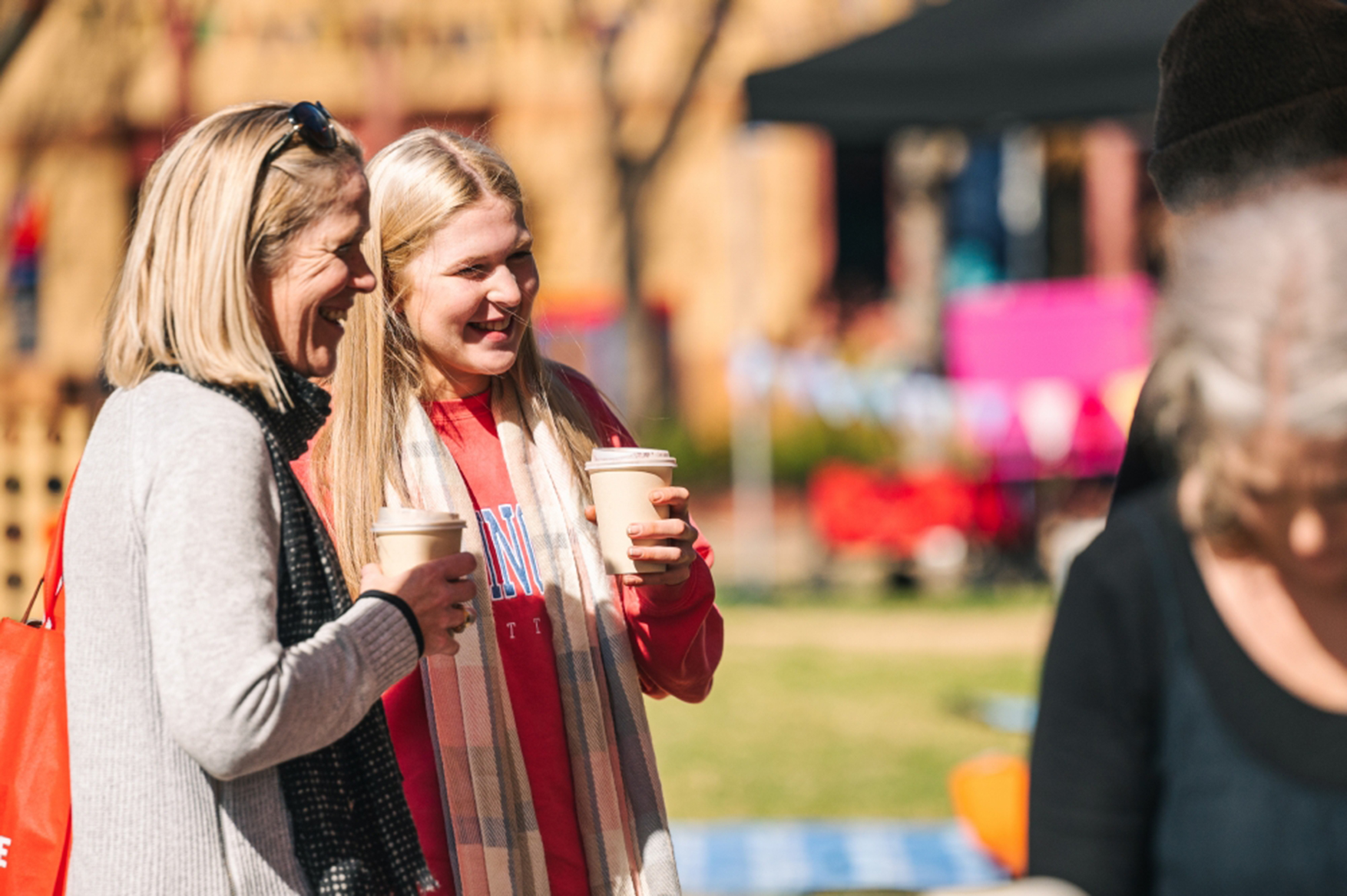 Two people at La Trobe event drinking coffee